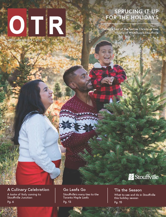 cover of on the road magazine with mom, dad, and son beside christmas tree