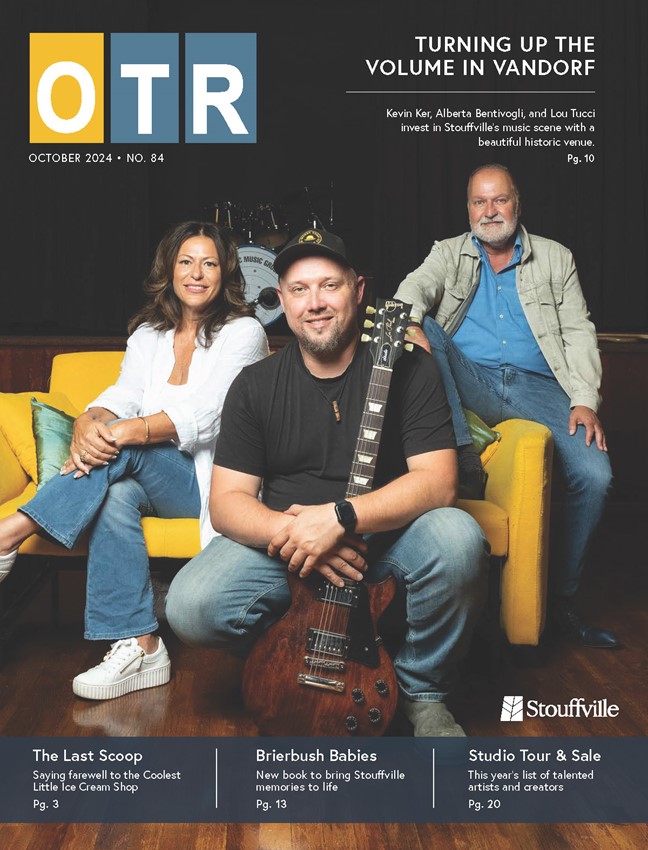 cover of OTR magazine with two men and a woman sitting on yellow couch, man in front holding a guitar